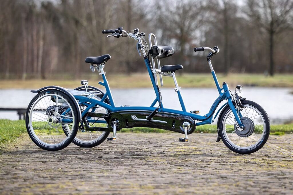 Van Raam Kivo Plus – Samen fietsen in alle stabiliteit en vertrouwen De Kivo Plus is dé ideale ouder-kind driewieltandem voor wie samen wil genieten van veilige en comfortabele fietstochten. Deze bijzondere tandem is ontworpen voor een volwassene die achterop zit en een kind dat voorop plaatsneemt. Zo heeft het kind goed zicht op de wereld om zich heen, terwijl de bestuurder altijd overzicht en controle houdt – óók over het kind. Wat de Kivo Plus uniek maakt, zijn de twee achterwielen, waardoor de fiets veel stabieler is dan een gewone tandem. Je kunt eenvoudig op- en afstappen, zelfs als de fiets stilstaat. Dankzij de lage instap aan beide zijden is de fiets toegankelijk voor jong én oud. 🚲 Slim en flexibel meefietsen met de schakelbare vrijloop Deze tandemtoppers hebben 8 versnellingen en een slimme vrijloopnaaf. Daarmee bepaal je zelf hoe actief het kind meedoet: Verplicht meefietsen – kind trapt automatisch mee Niet meefietsen – pedalen draaien vrij mee Vrij meefietsen – kind kiest zelf of en wanneer het trapt ⚡ Smart e-bike voor extra ondersteuning De optionele elektrische trapondersteuning maakt van de Kivo Plus een moderne smart e-bike. Via de gratis Van Raam app stel je eenvoudig het gewenste ondersteuningsniveau in. Dat maakt lange ritten samen nog aangenamer en minder inspannend. 🛠️ Standaard uitgerust met: 8 versnellingen V-brakes en schijfremmen Parkeerrem Fietsslot Snelspanner op het zadel Fietsbel en verlichting Schakelbare vrijloop Poedercoating in milieuvriendelijke lak Aluminium velgen 5 jaar garantie op het frame 💡 Voordelen op een rijtje: Perfect zicht voor zowel kind als begeleider Kind mag – maar hoeft niet – mee te trappen Achterste persoon stuurt en heeft controle Extra stabiel door twee achterwielen Lage instap voor beide personen Eenvoudige transfer voor het kind Makkelijk te besturen en veilig in gebruik Samen fietsen wordt met de Kivo Plus niet alleen weer mogelijk, maar ook een feest! Kom deze tandem zelf ontdekken en maak een proefrit bij Fietshemel Edam. We nemen graag de tijd om de mogelijkheden persoonlijk met je door te nemen.